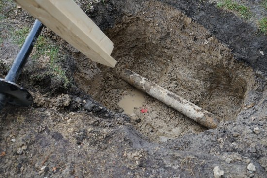 A lumber extension attached to a rafter revealed that a waste line was in the exact location where a pier needed to be drilled.