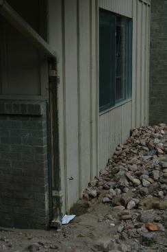 This apartment house was right in the active floodway and was pummeled with rocks tumbled along by strong water currents.
