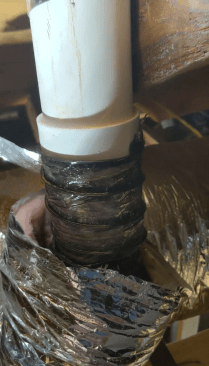 After cutting the duct to length, the author tapes its interior sleeve around the damper assembly.
