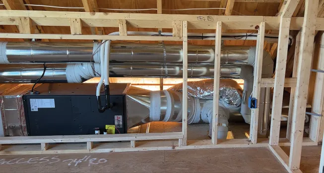 One of four air handlers in the house fits in an attic knee wall.