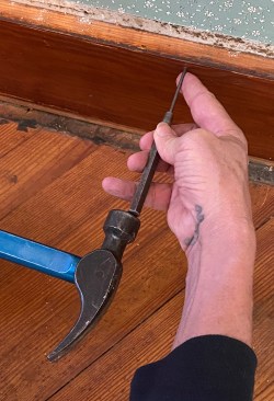When you need to preserve a board, you can't mar the face with a catspaw. Instead of pulling nails, use an 1/8-inch pin punch to drive finish nails through the back of the board. When the punch has been driven deep, it's sometimes hard to pull back out, but you can pry it out with the claw of a hammer.