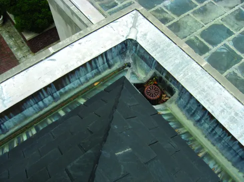 Drains are often positioned poorly, as in the corner of this gutter, where there is no room for a clamp ring and no room to solder. 