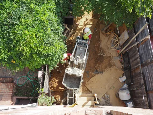 Inner-city access is often tight so concrete must be “walked” in through alleys and backyards.