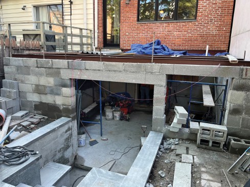 Set on top of the new foundation the completed beams were painted with red oxide primer.
