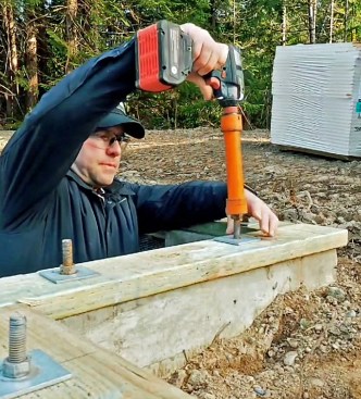 Working in a D2 seismic zone, the author is required to use 3-inch-square plate washers on anchor bolts. To save time, he tightens the nuts with an impact ratchet, being careful not to overdrive the nuts, as that can crack the concrete around the bolt. The rule is to seat the nut, then tighten it one half-turn.