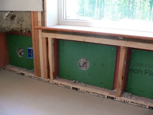 Another step in the repair work: cellulose insulation has been dense-blown into the cavity through the hole in the center of the ZIP sheathing patch.