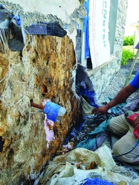 The base of the wall, where the lack of a weep screed allowed water to pool, had the worst rot.