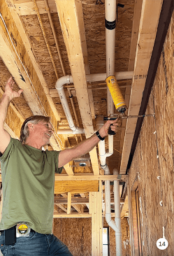 Once the home is dried-in, attention shifts to air-sealing and insulation. Site supervisor Matt Kulp of Daks Builders seals the gaps between the SIPs.