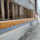 The new rim beam is built up of three 1 3/4-inch-by-7 1/4-inch LVL members, sized to not only support the distributed bearing load from the balloon-framed wall, but also to resist the lateral force of the new floor framing that will tie into it.