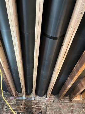 Before the seam is taped. Seen from the first floor, the MLV drapes between joists.