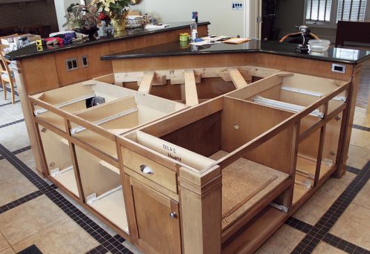 With the top out of the way, we found that the lower portion of the island consisted of two standard base cabinets in an L shape with 2x4 stretchers spanning the unused space behind.