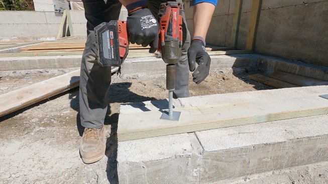 Kyle Davis of Pioneer Builders tightens down a Titen HD screw anchor.