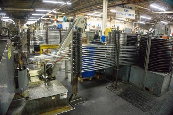 Multiple strips of bimetal material enter the machine on the left, where they will be stacked tight before having teeth cut into them by the type of cutter head shown in the previous slide. They essentially gang-cut the things. Talk about fast!