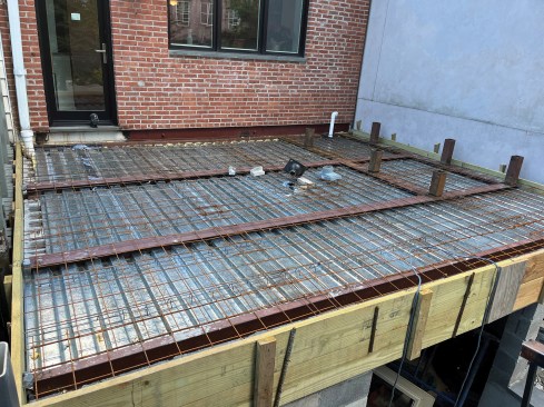Those short beams will support the square tubing stub-outs (shown here) that will connect to the fire escape. The deck, which will support the fire escape and serve as a patio, is ready to be poured.