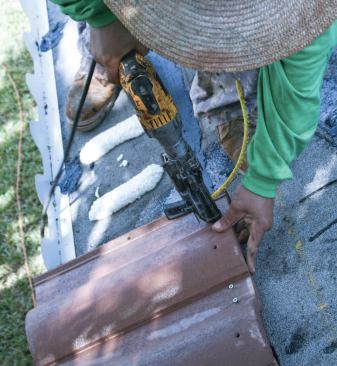 Second, two galvanized screws per tile, driven through a strip of cold-applied asphalt cement.