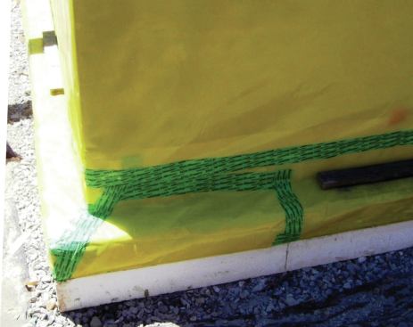 The air barrier under the footing and slab is also a vapor retarder and radon retarder. Here 10-mil Stego Wrap was taped with Siga Rissan tape. 
