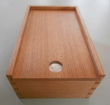 A dovetailed box made by the author from salvaged chestnut wood. The pull is inset with a 1902 half dollar from a time just before the blight