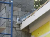 Once the roofing and step flashings are installed, a second counterflashing will cover the step flashing and connect to this through-flashing.