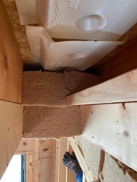 The integrity of  the fibers affords a high degree of precision fitting into odd-shaped framing cavities, such as this ceiling bay, but all this artistry comes at the cost of time.