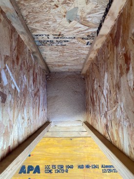 Using up scraps for the narrow insulation pieces adjacent to the top and bottom chords of I-joists, the crew production-cut the three-piece inserts along the band joist area of the floor. 