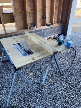 The author rigged a 16-inch beam saw on a plywood cutting station to rip batts, which sped up the process of fitting batts in I-joist cavities.