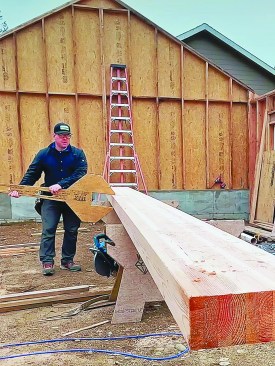 One way the author maneuvers a beam is with a “beam wrench,” which can be made on site with plywood or OSB scrap.