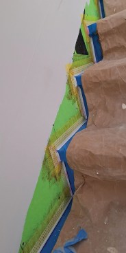 An L-bead is precisely installed about 1/16 to 1/8 inch above the finished surface using spray adhesive.