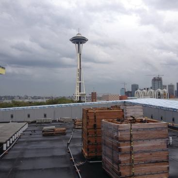 To avoid damage to the roofing, the author’s crew prefabricated modular 4-by-4-foot deck grids on the ground, stacked them on pallets, and lifted them up to the rooftop with a crane. 