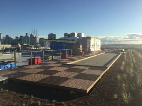 With the aluminum railing sections slipped down over the stanchions, the deck is nearing completion. Yet to be installed is the fascia, which will wrap around the entire deck to box it in.