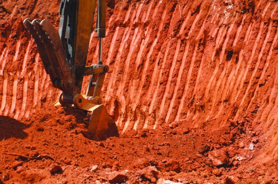 The author had to borrow red clay from off site to create a strong sub-base for the slab.