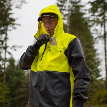 Although this jacket isn't breathable, the front zipper opens up quite a bit for circulation and ventilation. The front pocket is large enough for a cell phone and has snap buttons to keep it closed. 
