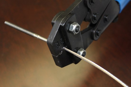 There are a variety of low cost crimping tools and smaller swaging tools meant for field installing cable fittings. Crimpers (which look a lot like a pair of bolt cutters) basically smash the fitting on to the cable with manual force, so multiple crimps are often necessary to achieve the proper connection. Hardware manufacturers call out specifications for the desired diameter of a crimp so that the installer knows they are getting the right amount of clamping force.