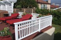 This railing was built with redwood and has a paint finish, though the same design could be built with reinforced composite balusters.