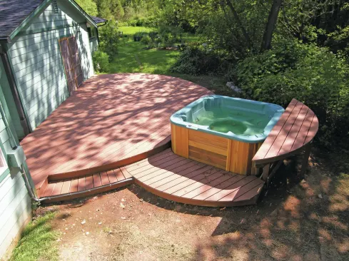 A spa table is a handy hot-tub option that can provide a place to sit and dangle feet in the water, or to set a drink. The table should be designed so that it doesn’t block access to the spa’s plumbing.