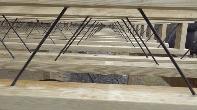 Blocking is required midspan and under bearing points but is easy to install because the open web of the joists (C) allows continuous blocking to be inserted from the side of the deck.