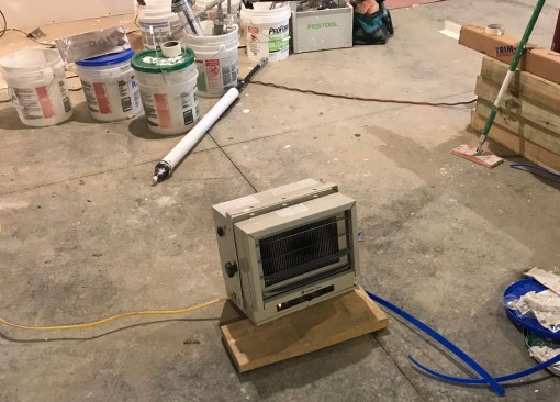 Electric heaters not only will warm the work space but also will help dry the interior.