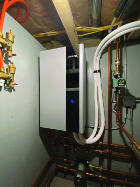 Copper refrigerant tubing, covered with white insulation, connects the outdoor unit (left) to the indoor unit (above).
