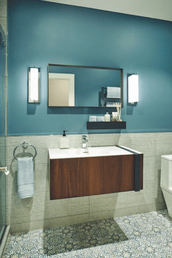 A Moroccan-inspired patterned floor tile, floating vanity, and serene blue paint provided a perfect ensemble for the pool-area bathroom.
