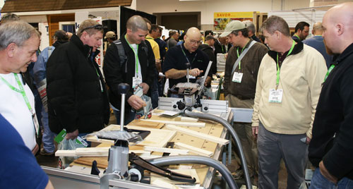 A group of JLC Live attendees check out new products on the tradeshow floor.