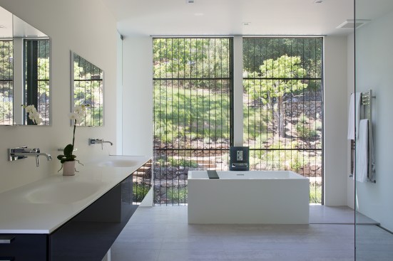 The master bath or "wet room" provides a relaxing space with optimal views to the natural surrounding without infringing on privacy.