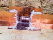 Note that the L-flashing laps over the scupper flanges and that these laps are bedded in a polyurethane caulk.