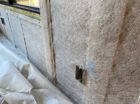 To avoid bulging bays when dense-packing walls, the author “lip-stitches” the membrane on the stud faces to pull it extra tight.