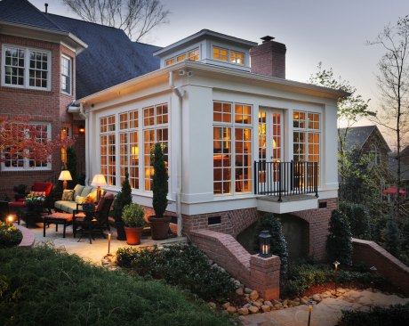 The sunroom opens onto a terrace which provides a connection to the outdoors and beautiful views of the surrounding landscape.