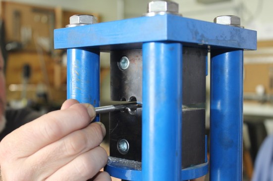 A true machine swage is created in a shop by a manufacturer or fabricator using either a rolling swagger or a press swagger (shown here). The process of swaging cold-forms the fitting around the cable using extreme force, resulting in a connection that should equal or exceed the breaking strength of the cable.