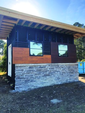 A thin adhered stone veneer in various colors and a rainscreen cladding system are mocked up.