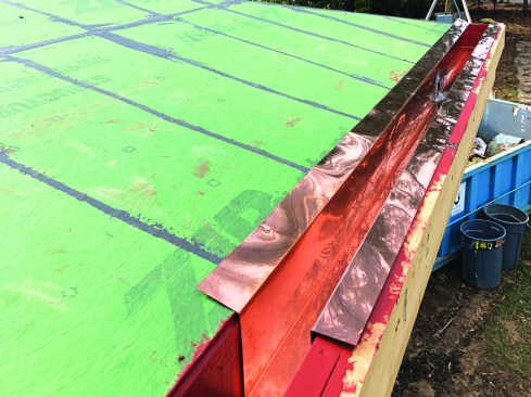 The roof has a wide overhang with a copper-lined hidden gutter.