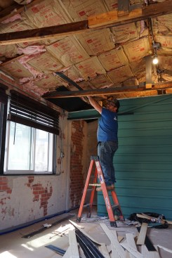 The crew begins by demolishing the ceiling. 