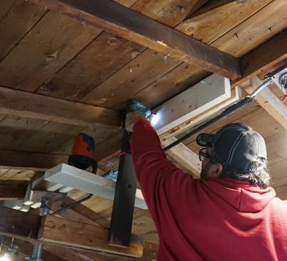 The crew installed blocks on both sides of the ridge board to support shoring for lifting the ridge.
