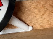 To lay down a well-bedded filet bead, the author prefers to push the gun, keeping a small, raised puddle of caulk in front of the tip.