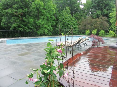 Measuring more than 2,000 square feet and well-suited for large gatherings around the pool, this bluestone patio was a cost-effective extension of the adjacent ipe deck.
